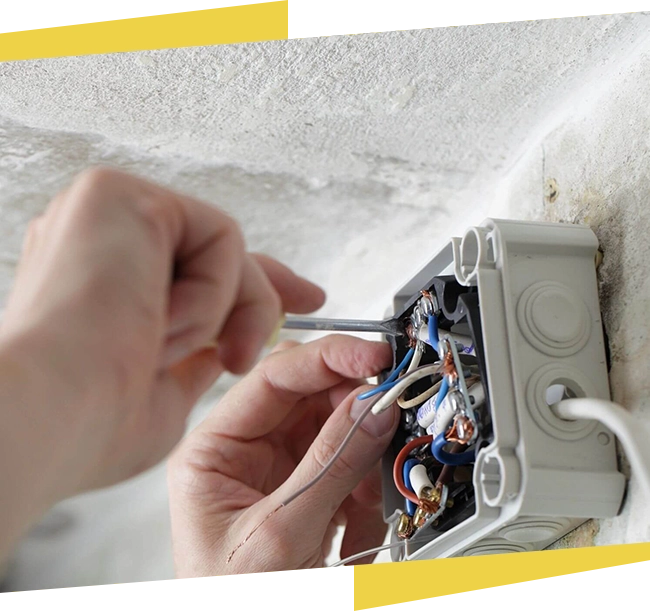 A person is working on an electrical box.